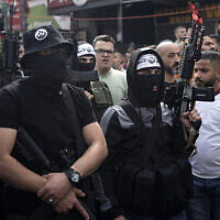 Gunmen wearing Lions's Den headbands and insignia attend the funeral in Nablus of Tamer al-Kilani, a top fighter in the Palestinian terror group, who it said was killed by an explosive device planted in a motorcycle, October 23, 2022. (AP Photo/Majdi Mohammed)
