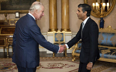 King Charles III (right) welcomes Rishi Sunak during an audience at Buckingham Palace, London, where he invited the newly elected leader of the Conservative Party to become prime minister and form a new government, October 25, 2022. (Aaron Chown/Pool photo via AP)
