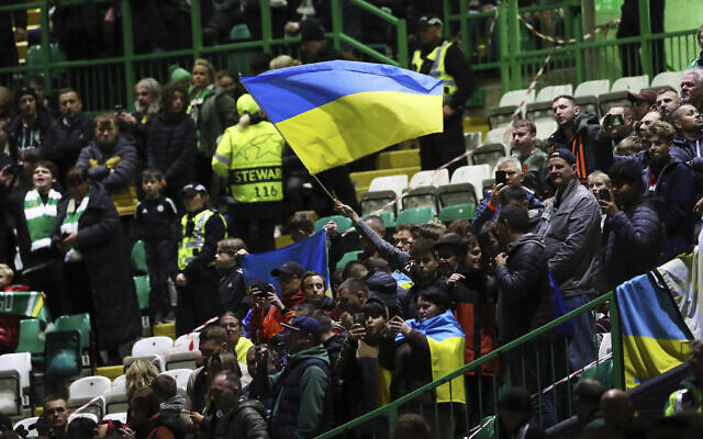 Spectators wave Ukrainian flag before the start of the Champions League Group F soccer match between Celtic and Shakhtar Donetsk at Celtic park, Glasgow, Scotland, October 25, 2022. (AP Photo/Scott Heppell)