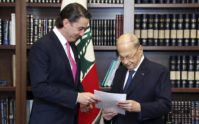In this photo released by Lebanon's official government photographer Dalati Nohra, Lebanese President Michel Aoun, right, receives from US Envoy for Energy Affairs Amos Hochstein, the US-brokered deal setting a maritime border between Lebanon and Israel, at the presidential palace, in Beirut, Lebanon, Thursday, Oct. 27, 2022.  (Dalati Nohra via AP)