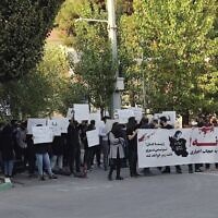 In this photo taken by an individual not employed by the Associated Press and obtained by the AP outside Iran, students of Sharif University of Technology holding banners saying: "No to mandatory hijab" and "Dear Zhina, (Mahsa Amini's nickname), you won't die, your name will become a symbol," during a protest sparked by the death of 22-year-old Amini in the custody of the country's morality police, in Tehran, October 7, 2022. (AP Photo)