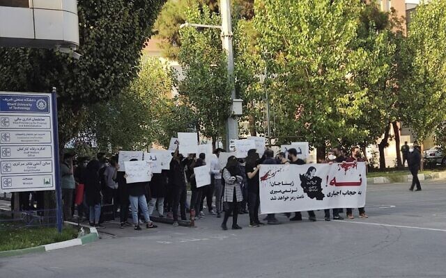 In this photo taken by an individual not employed by The Associated Press and obtained by the AP outside Iran, students of Sharif University of Technology holding banners saying: 'No to mandatory hijab' and 'Dear Zhina, (Mahsa Amini's nickname), you won't die, your name will become a symbol,' during a protest sparked by the death of 22-year-old Amini in the custody of the country's morality police, in Tehran, October 7, 2022. (AP Photo)
