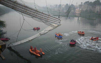 Search and rescue work is going on as a cable suspension bridge collapsed in Morbi town of western state Gujarat, India, Monday, Oct. 31, 2022. (AP/Ajit Solanki)