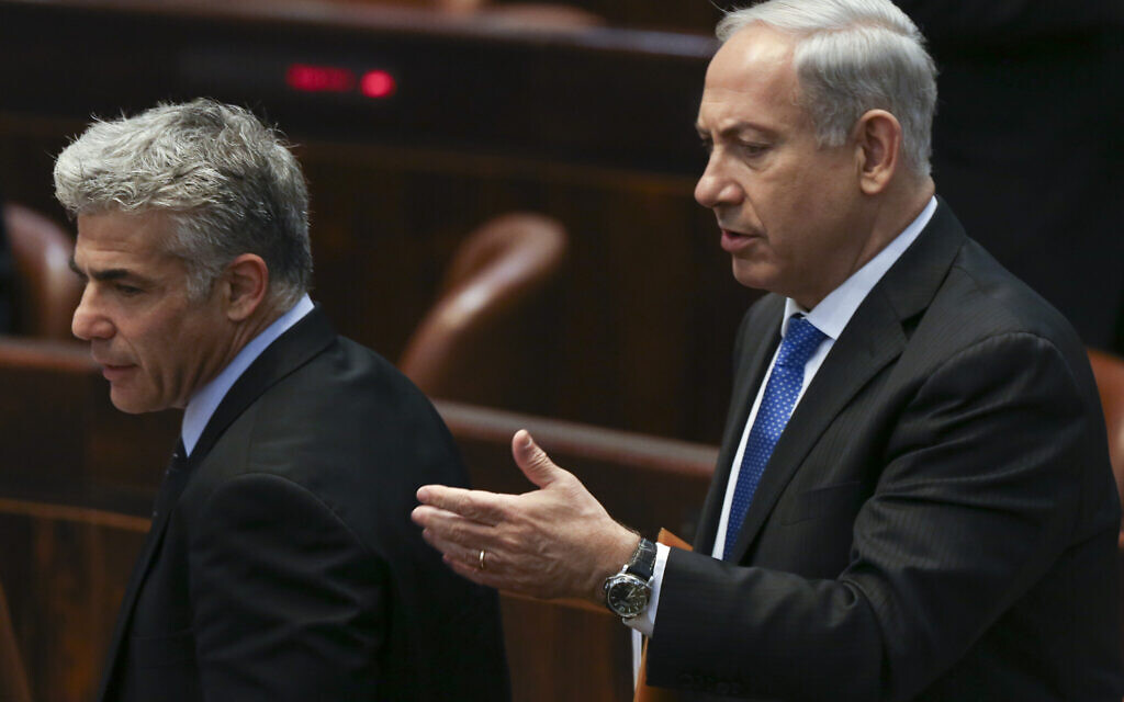 File: Then-prime minister Benjamin Netanyahu, right, and then-finance minister Yair Lapid in the Knesset on July 8, 2013. (Yonatan Sindel/FLASH90)