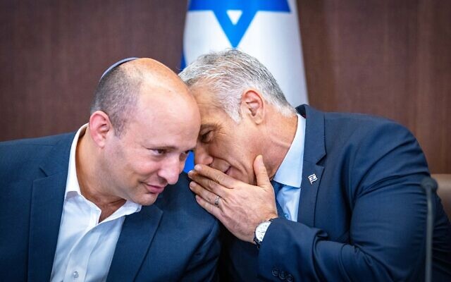 Prime Minister Yair Lapid (R) with Alternate Prime Minister Naftali Bennett at a cabinet meeting at the Prime Minister's Office in Jerusalem on September 18, 2022. (Olivier Fitousi/ Flash90)