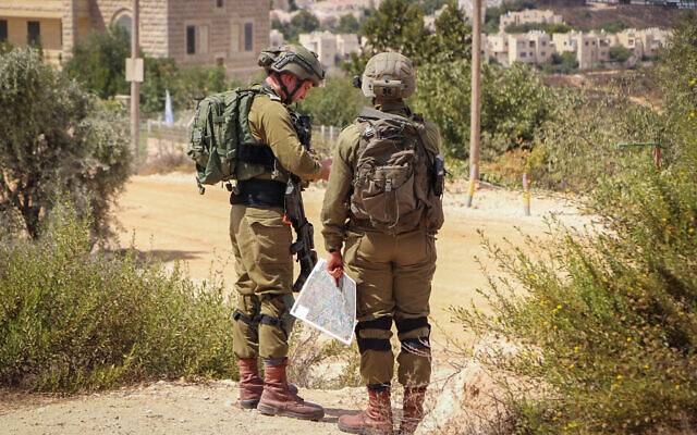 Illustrative: Israeli soldiers hold a drill simulating an infiltration of terrorists into the settlement of Elazar in the West Bank, September 21, 2022. (Gershon Elinson/Flash90)