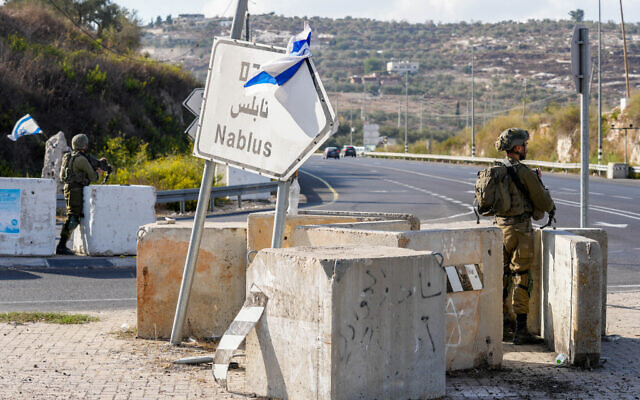 Israeli soldiers stand guard near the West Bank village of Huwara, near Nablus, October 13, 2022. (Erik Marmor/Flash90)