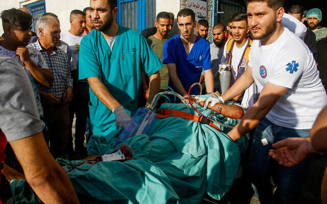 Wounded Palestinians who were injured during clashes with Israeli security forces in the town of Qarawat Bani Hassan, arrive at a hospital, October 15, 2022. (Nasser Ishtayeh/Flash90)