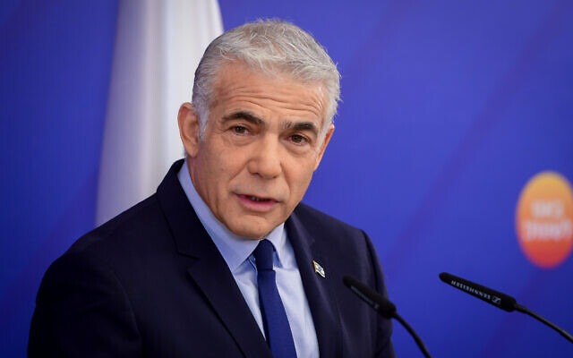 Prime Minister and Yesh Atid party leader Yair Lapid speaks during a faction meeting in Tel Aviv on October 18, 2022. (Avshalom Sassoni/Flash90)