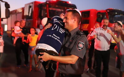 Israeli fire fighters recieve a Torah from Jewish National Fund-USA