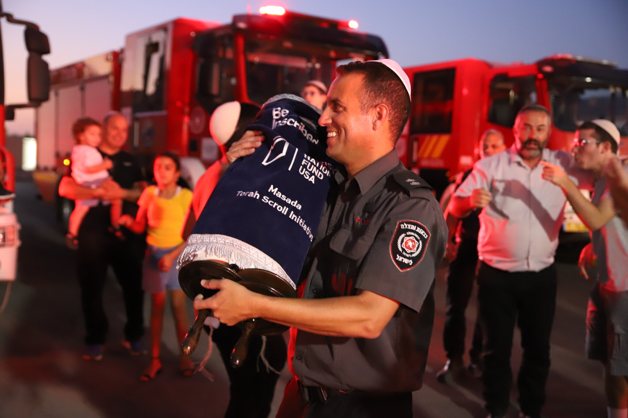 Israeli fire fighters recieve a Torah from Jewish National Fund-USA