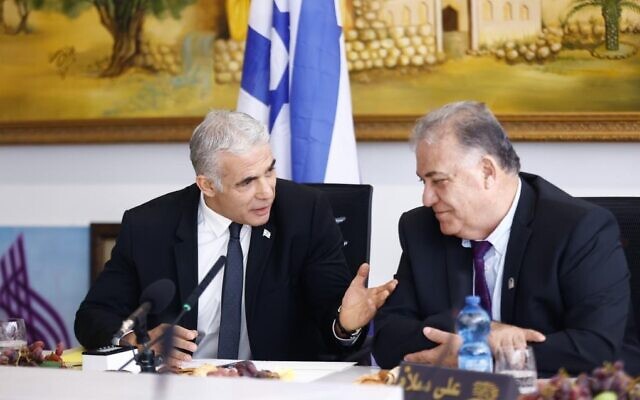 Prime Minister Yair Lapid (L) meets with Nazareth Mayor Ali Salem during a visit to the northern city on October 25, 2022. (Kobi Wolf)