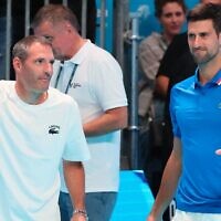 Israeli Jonathan Erlich appears with his friend and former doubles partner Novak Djokovic, right, to explain the cancellation of their scheduled match at the Tel Aviv Watergen Open in Tel Aviv, Sept. 28, 2022. (Jack Guez/AFP via Getty Images via JTA)