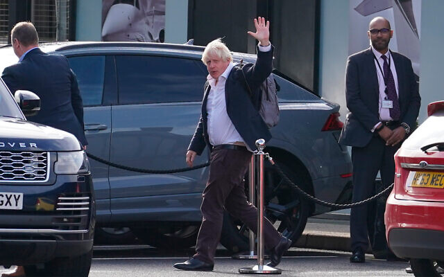 Former British prime minister Boris Johnson arrives at Gatwick Airport in London, after traveling on a flight from the Caribbean, October 22, 2022. (Gareth Fuller/PA via AP, File)
