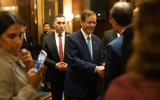 President Isaac Herzog shakes hands with Jewish American leaders in Washington on October 25, 2022. (Luke Tress/Times of Israel)