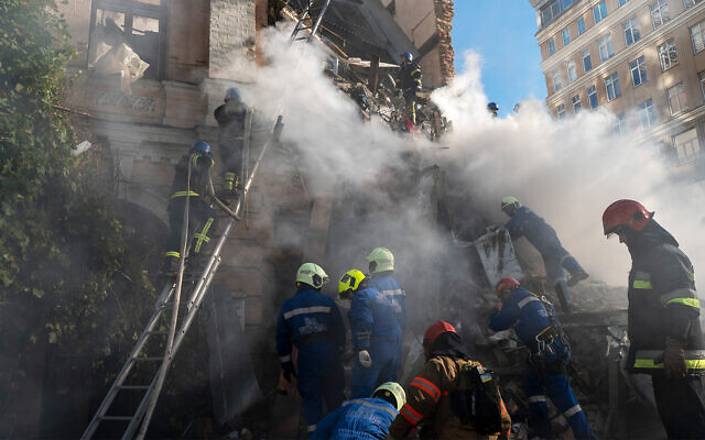 Firefighters work after a drone hit on buildings in Kyiv, Ukraine, Oct. 17, 2022. (AP Photo/Roman Hrytsyna)