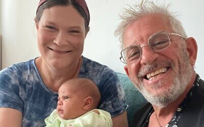 Tzvia, the Israeli woman who gave birth after reversing her menopause by transplanting part of her ovary which had been frozen for 20 years, with her baby and her physician Prof. Ariel Revel. (courtesy of Prof. Ariel Revel)