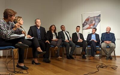 From left, journalist Nurit Canetti, Yisrael Beytenu's Sharon Roffe-Ofir, Labor's Gilad Kariv, Meretz's Michal Rozin, Jewish Home's Yomtob Kalfon, Yesh Atid's Idan Roll, Religious Zionism's Ohad Tal and Blue-and-White's Alon Tal, appear on stage during an election event on Israel-Diaspora ties at Tel Aviv's ANU Museum of the Jewish People on October 19, 2022. (Barak Sela/Reut Group/Courtesy)