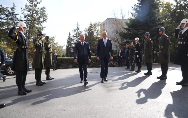 Defense Minister Benny Gantz (R) walks with his Turkish counterpart, Hulusi Akar, in Ankara on October 27, 2022. (Elad Malka/Defense Ministry)