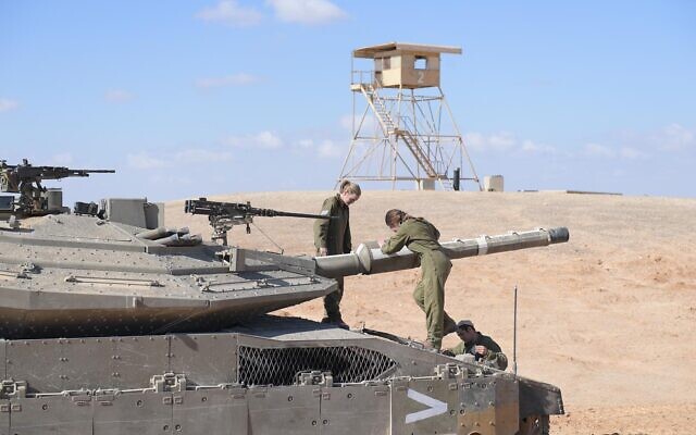 Female soldiers operate a tank in the Negev desert in an undated photograph. (Israel Defense Forces)