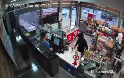 A 14-year-old boy robs a convenience store in Ashkelon with an axe, October 2, 2022. (Screen grab: Twitter)