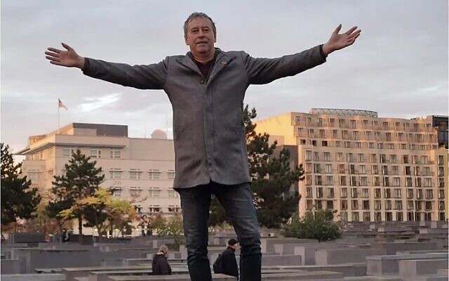 Alternative for Germany representative Holger Winterstein posing with outstretched arms on one of the stone slabs that form the Holocaust Memorial in Berlin (Twiter:  used in accordance with Clause 27a of the Copyright Law)