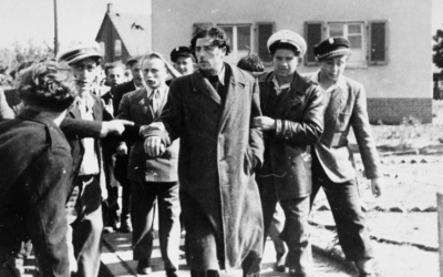 Jewish police detaining a former kapo who was recognized by former concentration camp inmates in the Zeilsheim Displaced Persons camp, Germany, ca. 1945. (United States Holocaust Memorial Museum, courtesy of Alice Lev)
