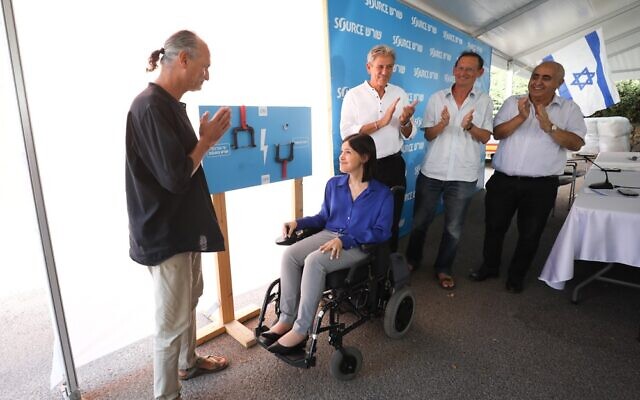 Yoram Gill, founder and chairman of Shoresh/Source sandals, welcomes Energy Ministry Karine Elharrar and dignitaries at the production plant in Tirat Carmel in northern Israel, September 22, 2022. (Liron Cohen Aviv, for Shoresh/Source)