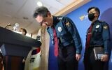 South Korea's National Police Agency Commissioner Yoon Hee-keun (C) bows during a press conference on the deadly Halloween crowd surge, at the Seoul Metropolitan Police Agency in Seoul on November 1, 2022. (YONHAP / AFP)