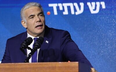 Prime Minister Yair Lapid addresses supporters of his Yesh Atid party at its campaign headquarters in Tel Aviv, early on November 2, 2022, after the announcement of exit polls. (Gil Cohen-Magen/AFP)