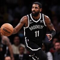 In this photo from  November 1, 2022, Kyrie Irving of the Brooklyn Nets brings the ball up the court during a game against the Chicago Bulls at Barclays Center in New York City. (Dustin Satloff/Getty Images North America/AFP)