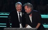 US singer-songwriter John Mellencamp (R) gives the Ahmet Ertegun Award to lawyer Allen Grubman during the 37th Annual Rock and Roll Hall of Fame Induction Ceremony at the Microsoft Theatre on November 5, 2022, in Los Angeles, California. (VALERIE MACON / AFP)