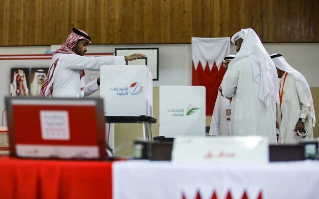 Bahraini poll clerks prepare ballot boxes at a polling station on the island of Muharraq, north of the capital Manama, during parliamentary elections, on November 12, 2022. (Photo by AFP)
