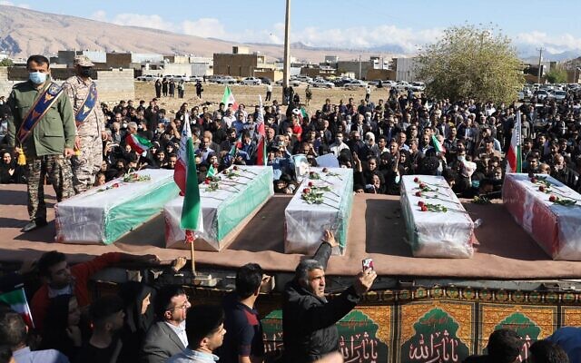 Iranians mourn in front of the coffins of people killed in a shooting attack, during their funeral in the city of Izeh in Iran's Khuzestan province, on November 18, 2022. (ALIREZA MOHAMMADI/ isna/ AFP)