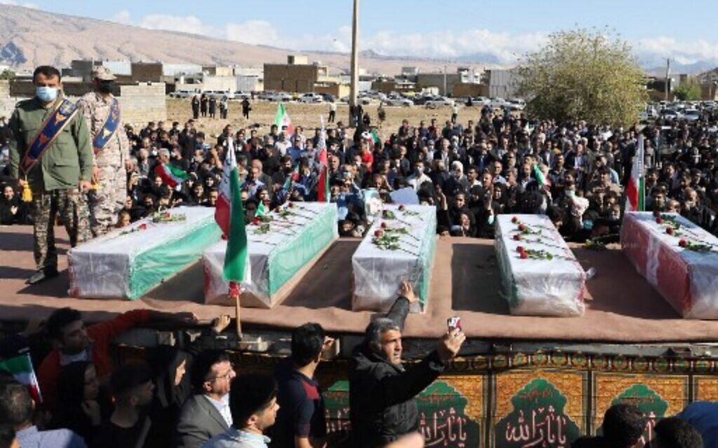 Iranians mourn in front of the coffins during a funeral for people killed in a shooting attack, in the city of Izeh in Iran's Khuzestan province, on November 18, 2022. (ALIREZA MOHAMMADI/isna/AFP)