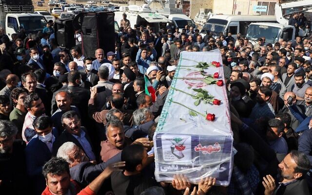 Iranians carry the coffin of one of the people killed in a shooting, during their funeral in the city of Izeh in Iran's Khuzestan province, on November 18, 2022. (ALIREZA MOHAMMADI/isna/AFP)
