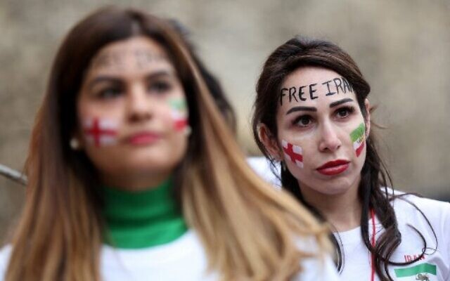 British-Iranian women take part in a demonstration opposite the Houses of Parliament in central London on November 19, 2022, ahead of Iran's fixture against England in the 2022 FIFA World Cup.(ISABEL INFANTES / AFP)