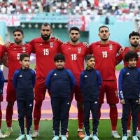 Iran players listen to the national anthem ahead of the Qatar 2022 World Cup Group B football match between England and Iran at the Khalifa International Stadium in Doha on November 21, 2022. (FADEL SENNA/AFP)