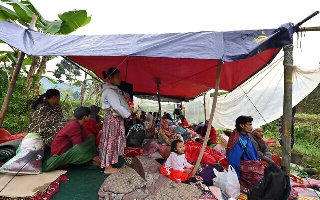 People stay at a temporary shelter following a 5.6-magnitude earthquake that killed at least 268 people, with many hundreds injured and others missing in Cianjur on November 22, 2022. (Photo by ADEK BERRY / AFP)