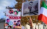 People hold placards bearing portraits of Iranian rapper Toomaj Salehi (R), who is arrested in Iran, and portraits of children (L), who were killed during the protests in Iran, during a rally in support of Iranian women in Istanbul, on November 26, 2022. (Yasin AKGUL / AFP)
