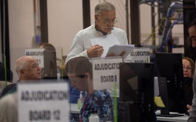An adjudication board reviews ballots at the Maricopa County Tabulation and Election Center on November 8, 2022 in Phoenix, Arizona. (John Moore/Getty Images/AFP)