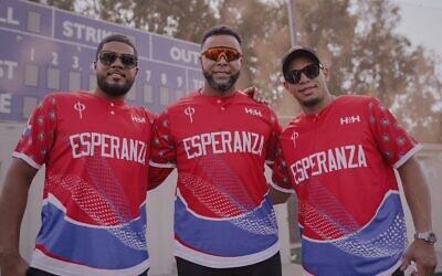 From left, Jeimer Candelario, Nelson Cruz and Cesar Hernandez pose for a photo at a baseball field in Ra'anana, Israel. (Nico Andre' Duran via JTA)