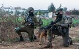 A female dog handler from the elite Oketz unit is seen during an arrest raid in the West Bank, early November 17, 2022. (Israel Defense Forces)