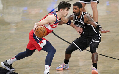 Illustrative: Brooklyn Nets guard Kyrie Irving (11) defends Washington Wizards forward Deni Avdija (9) as Avdija drives toward the Wizards basket during the second quarter of a preseason NBA basketball game, December 13, 2020, in New York. (AP Photo/Kathy Willens)
