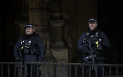 Illustrative: Armed British police officers stand guard, in London, January 7, 2021.  (Matt Dunham/AP/File)