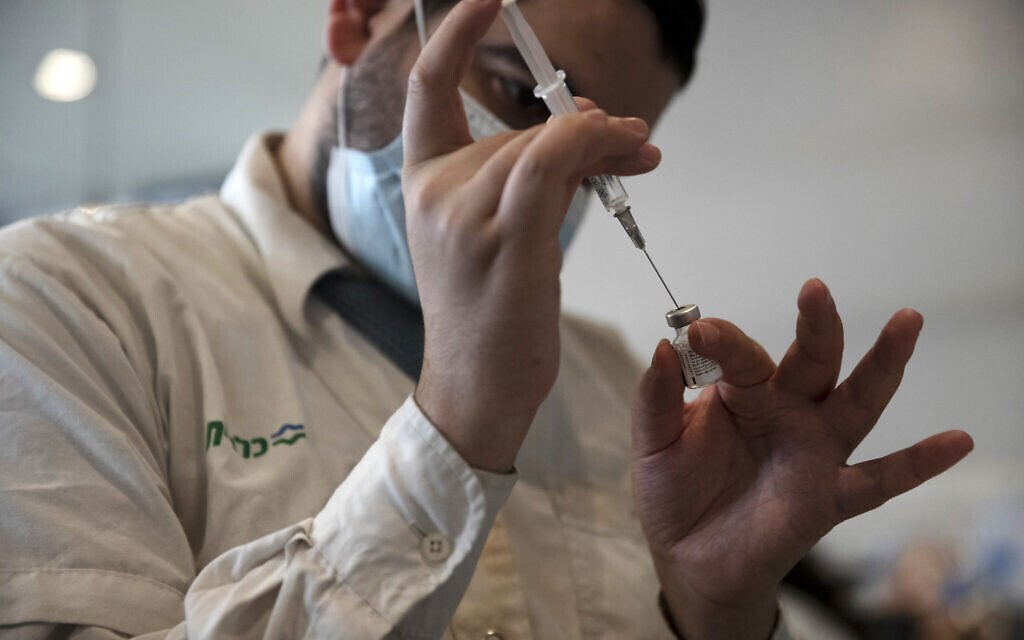 Illustrative image: A medical worker prepares a vial of the Pfizer coronavirus vaccine at Clalit Health Service's center in the Cinema City complex in Jerusalem, on Wednesday, Sept. 22, 2021. (AP Photo/Maya Alleruzzo)