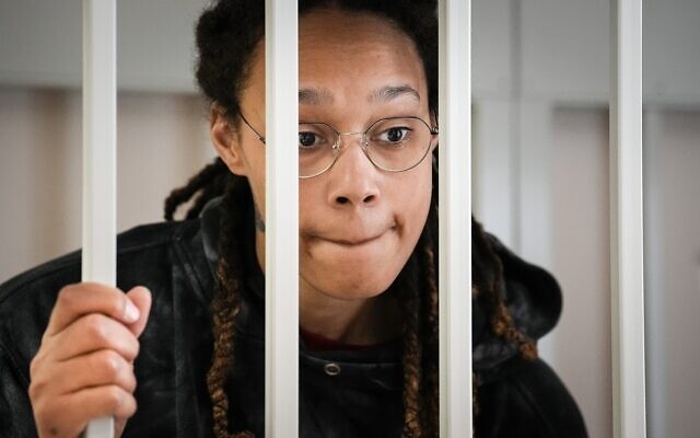 WNBA star and two-time Olympic gold medalist Brittney Griner speaks to her lawyers standing in a cage at a court room prior to a hearing, in Khimki just outside Moscow, Russia, Tuesday, July 26, 2022 (AP Photo/Alexander Zemlianichenko)