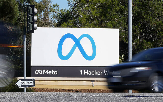 A car passes Facebook's new Meta logo on a sign at the company headquarters in Menlo Park, California, on October 28, 2021. (Tony Avelar/AP)