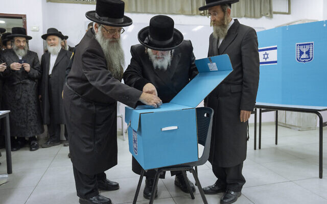 Ultra-Orthodox Jews watch their Rabbi Israel Hager votes during Israel elections in Bnei Brak, Tuesday, Nov. 1, 2022. Israel is holding its fifth election in less than four years. (AP Photo/Oded Balilty)