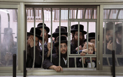 Ultra-Orthodox Jews watch as their rabbi votes in Bnei Brak, Nov. 1, 2022 (AP Photo/Oded Balilty)